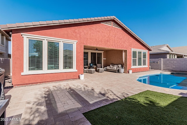 rear view of house featuring ceiling fan, a patio area, a fenced in pool, and an outdoor hangout area