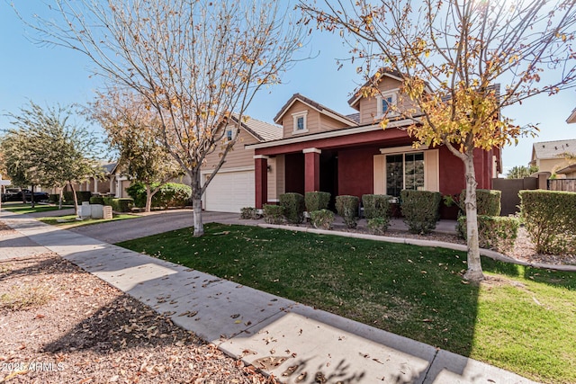 view of front of home with a front yard and a garage