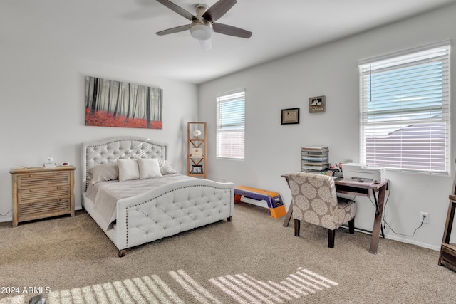 carpeted bedroom featuring multiple windows and ceiling fan