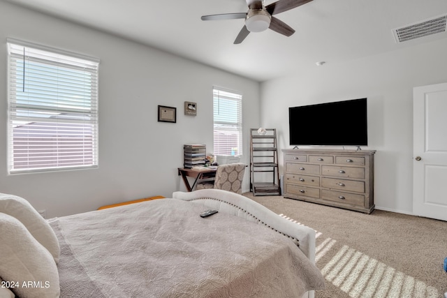 carpeted bedroom featuring ceiling fan, visible vents, and baseboards