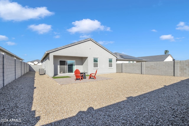 rear view of house featuring central air condition unit and a patio