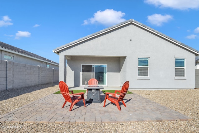 back of property featuring a tile roof, fence, a patio, and stucco siding