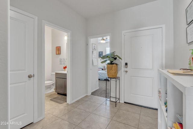 entryway with light tile patterned floors and ceiling fan