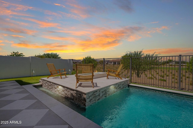 pool at dusk with a fenced in pool, a patio area, and fence