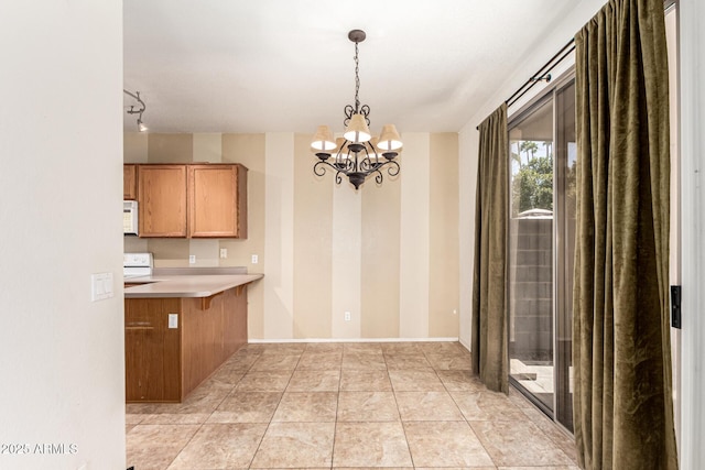 unfurnished dining area with a chandelier