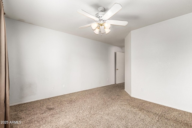 empty room with carpet flooring and a ceiling fan