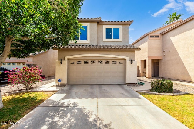 view of front of house with a garage, stucco siding, a tiled roof, and concrete driveway