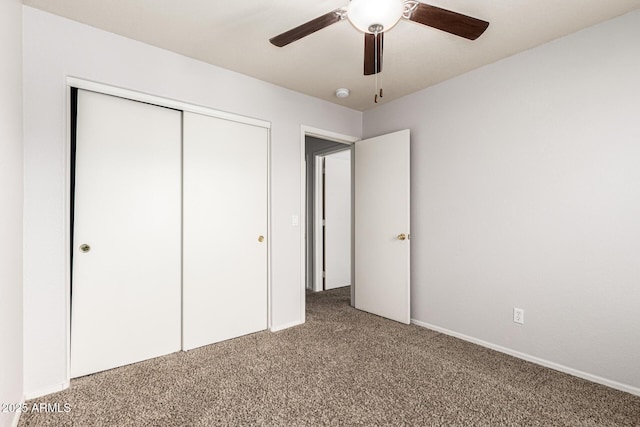 unfurnished bedroom with ceiling fan, light colored carpet, baseboards, and a closet