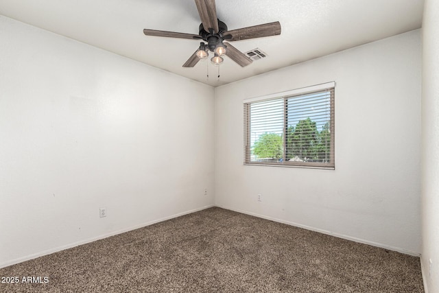 empty room with baseboards, ceiling fan, carpet flooring, and visible vents