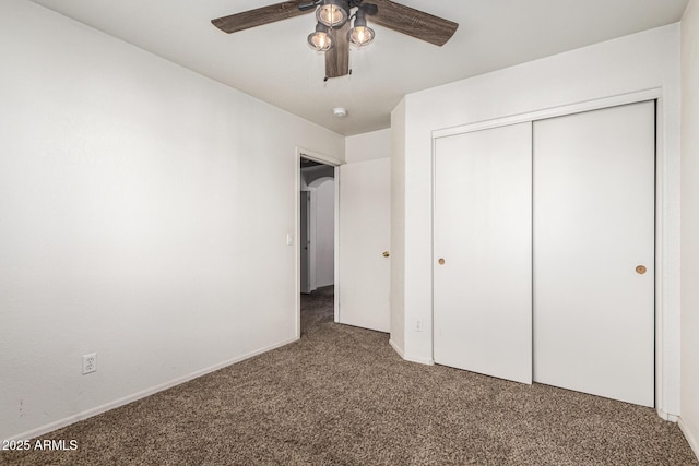 unfurnished bedroom with a closet, baseboards, ceiling fan, and carpet flooring