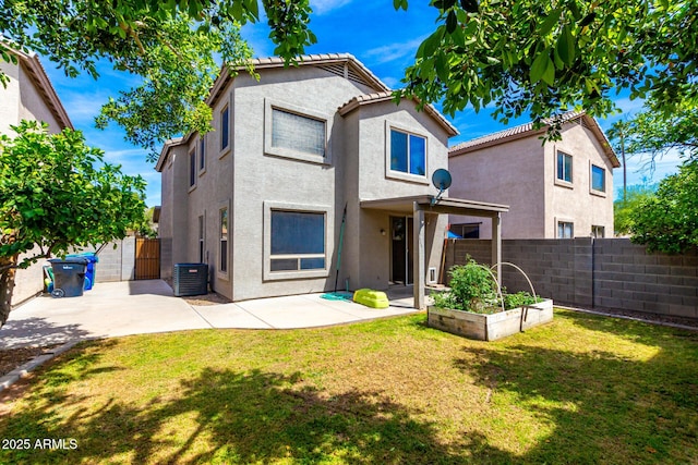 back of property with a patio area, cooling unit, a fenced backyard, a yard, and stucco siding