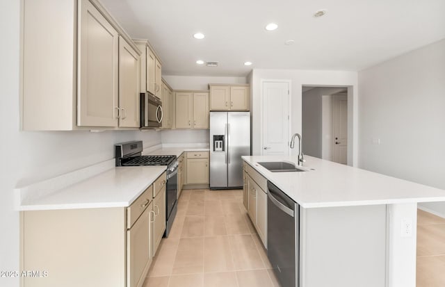 26995 W Adam Ave, Buckeye, AZ 85396 - kitchen featuring appliances with stainless steel finishes, a sink, light tile patterned flooring, cream cabinetry, and light countertops