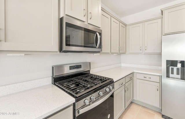 26995 W Adam Ave, Buckeye, AZ 85396 - kitchen with appliances with stainless steel finishes, light tile patterned floors, and light stone countertops
