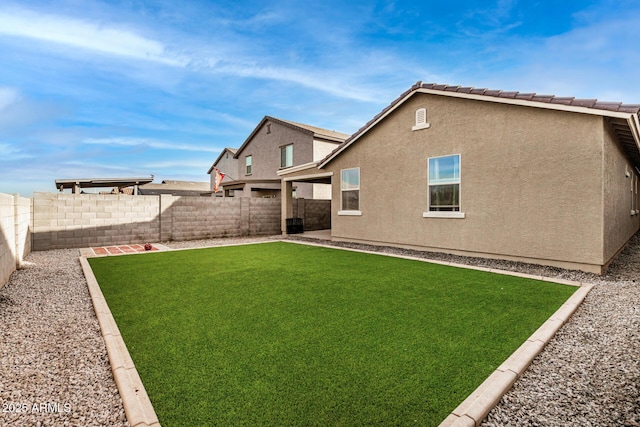 back of house with a lawn