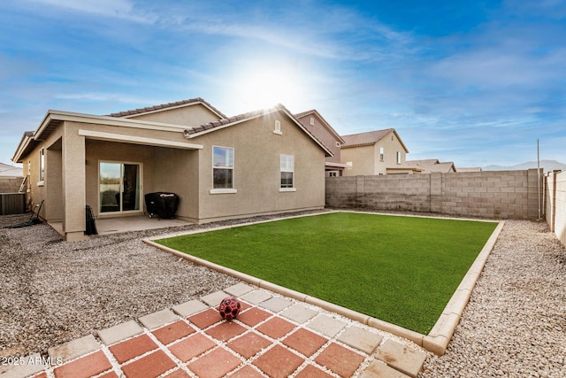 back of house with a patio area, a lawn, and central air condition unit