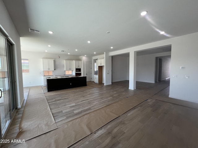 kitchen featuring light wood-type flooring, visible vents, recessed lighting, and white cabinetry