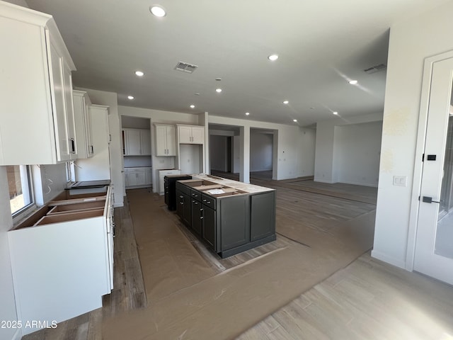 kitchen with recessed lighting, visible vents, and white cabinets