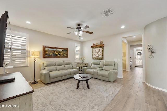 living room with a healthy amount of sunlight, ceiling fan, and light hardwood / wood-style floors