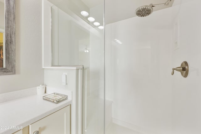 bathroom featuring ceiling fan and walk in shower