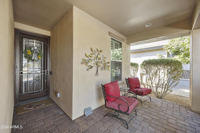 view of exterior entry featuring covered porch