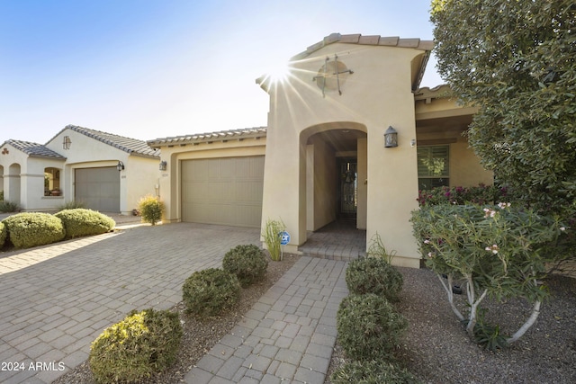 mediterranean / spanish-style house with a garage