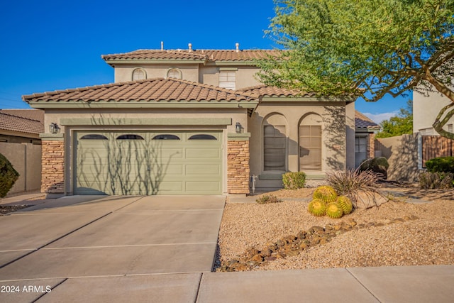 mediterranean / spanish house featuring a garage