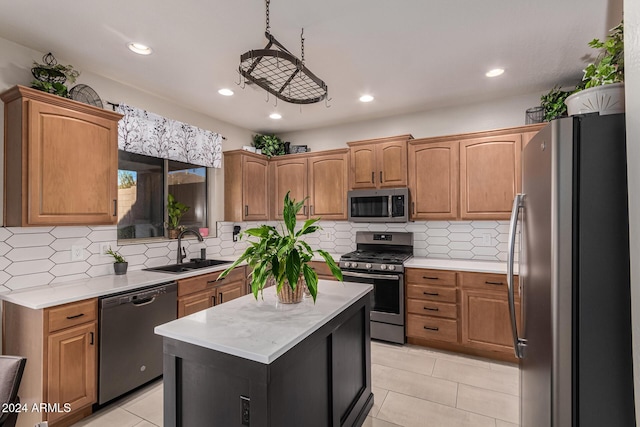 kitchen featuring a center island, backsplash, sink, appliances with stainless steel finishes, and light tile patterned flooring