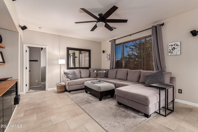 living room with ceiling fan and light tile patterned flooring