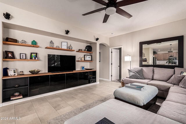 tiled living room with ceiling fan