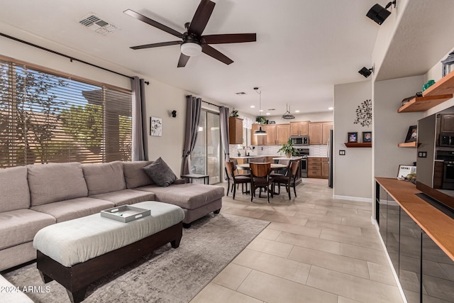 living room with light tile patterned floors and ceiling fan