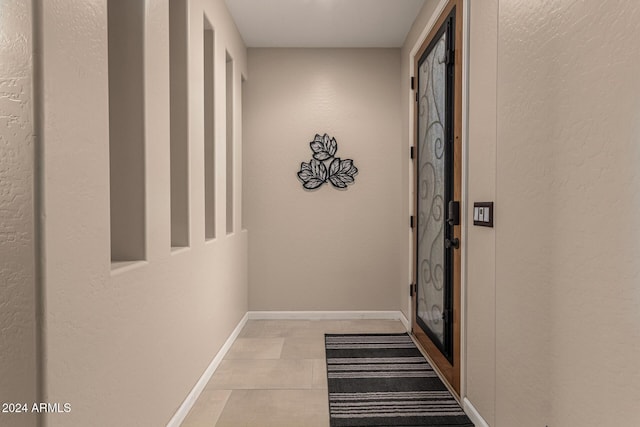 corridor with light tile patterned floors