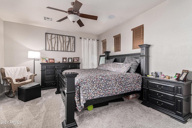 bedroom featuring light carpet and ceiling fan