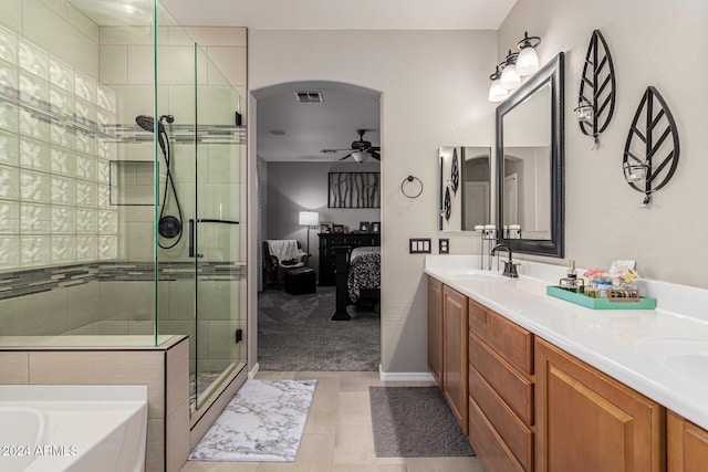 bathroom featuring tile patterned floors, ceiling fan, independent shower and bath, and vanity