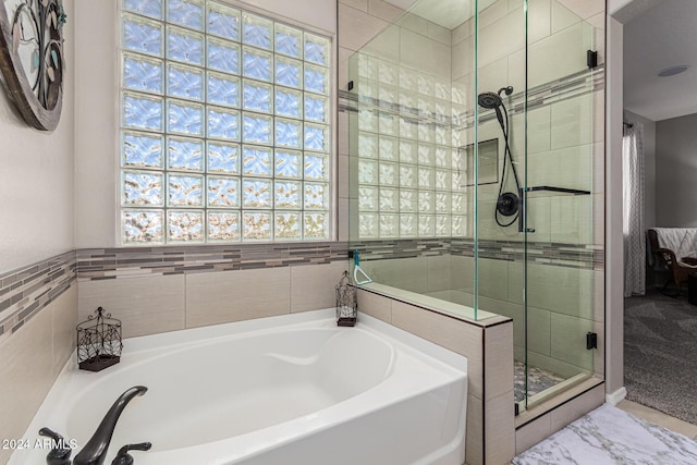 bathroom with shower with separate bathtub