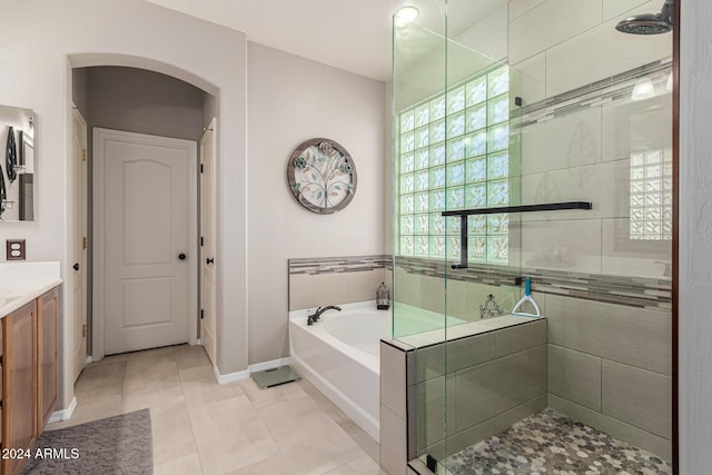 bathroom with tile patterned floors, vanity, and separate shower and tub