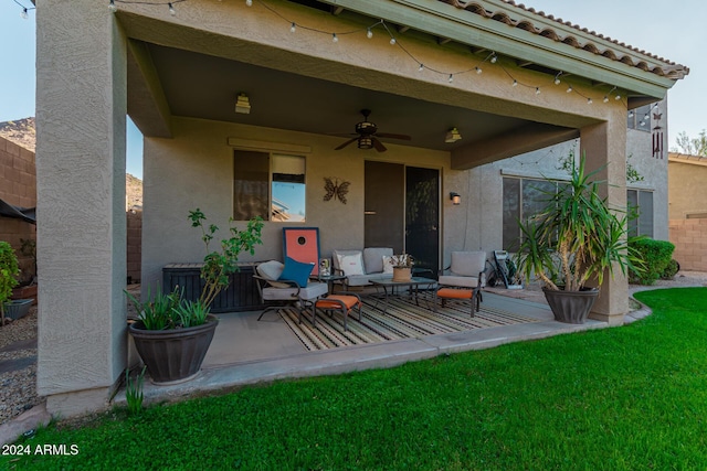 back of property with ceiling fan and a patio area