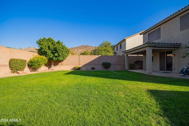 view of yard featuring a mountain view and a patio