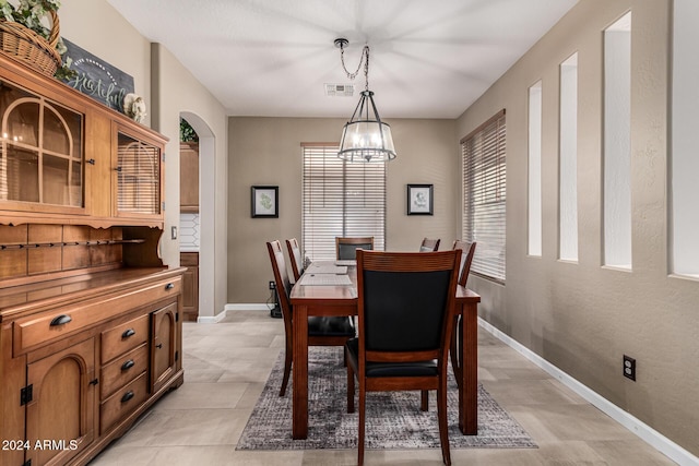 dining room with an inviting chandelier and light tile patterned flooring