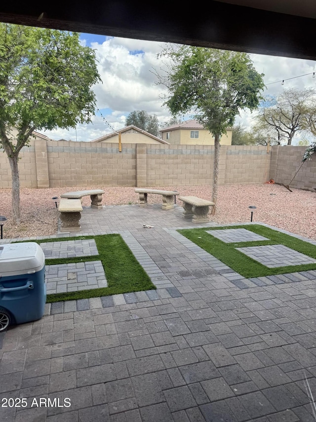 view of yard with a fenced backyard and a patio