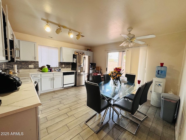 dining room featuring ceiling fan and wood finish floors