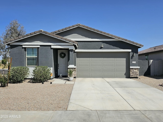 single story home featuring stucco siding, stone siding, a tile roof, an attached garage, and driveway