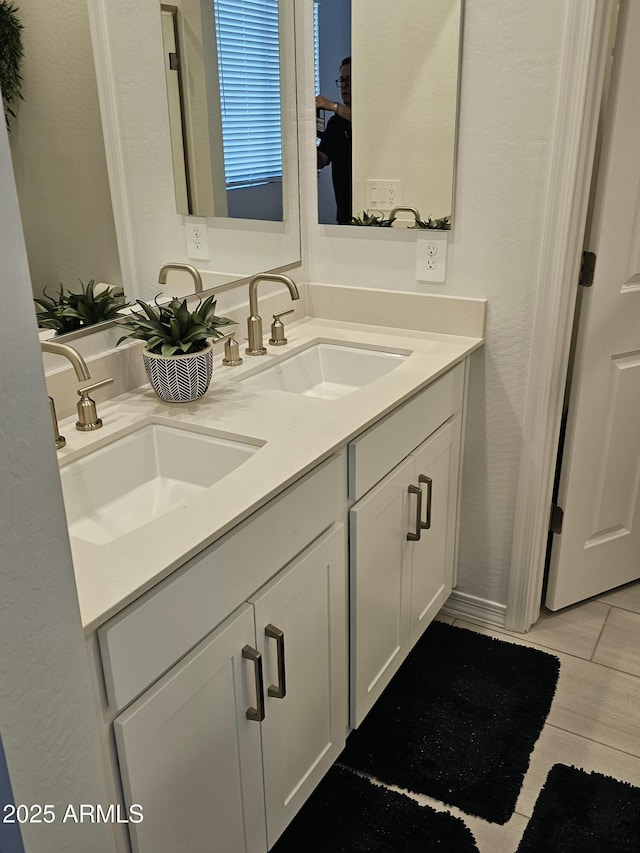 bathroom with double vanity and a sink