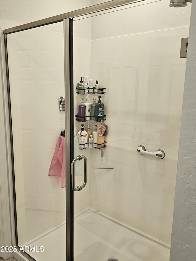 full bath featuring a shower stall