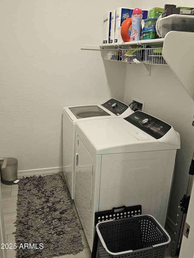 laundry room with washer and clothes dryer, laundry area, and baseboards