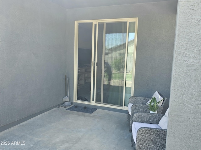 exterior space with a patio area and stucco siding