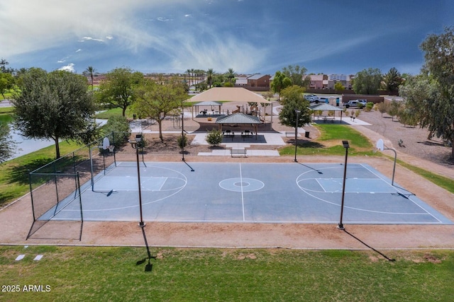 view of basketball court with community basketball court, a gazebo, fence, and a lawn