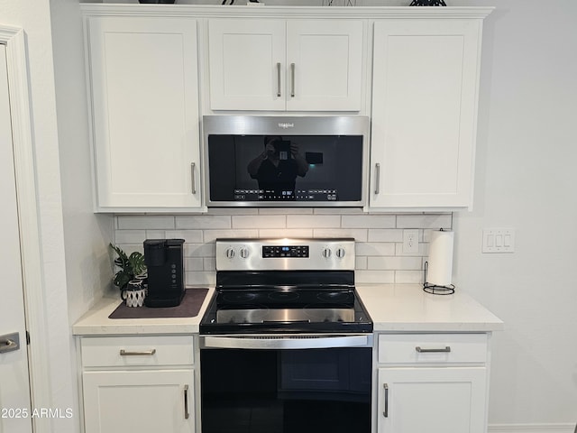 kitchen featuring tasteful backsplash, light countertops, appliances with stainless steel finishes, and white cabinetry