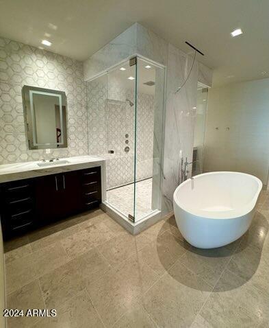 6587 N Palmeraie Blvd Unit 2022, Paradise Valley, AZ 85253 - full bathroom with vanity, a shower stall, and a freestanding bath