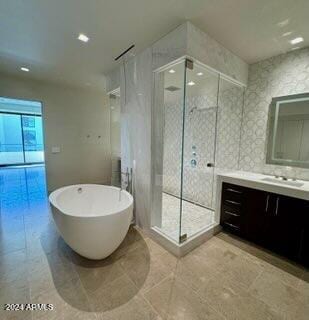 6587 N Palmeraie Blvd Unit 2022, Paradise Valley, AZ 85253 - bathroom with vanity, a shower stall, a freestanding bath, recessed lighting, and tile patterned flooring