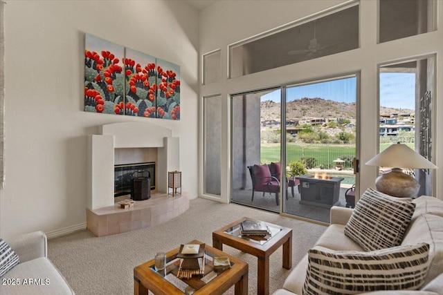 9432 N Longfeather, Fountain Hills, AZ 85268 - carpeted living room featuring a high ceiling, a fireplace, and baseboards